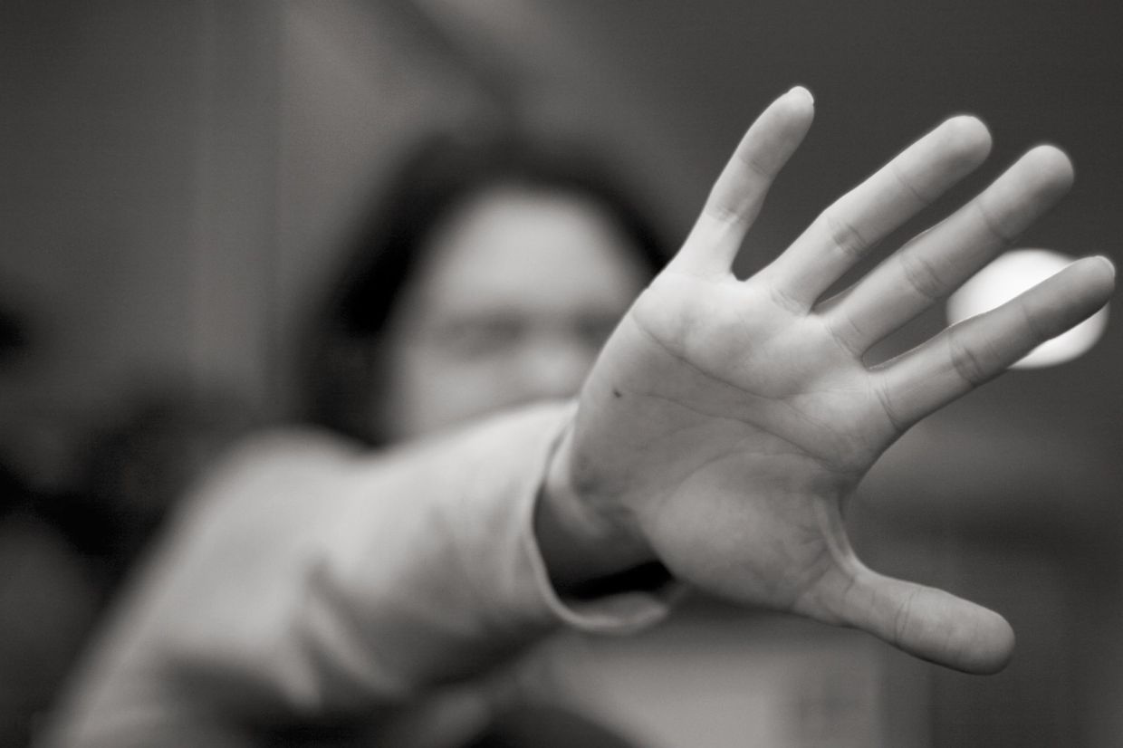 [IMAGE] A pale hand is in the foreground blocking an unidentified person's face