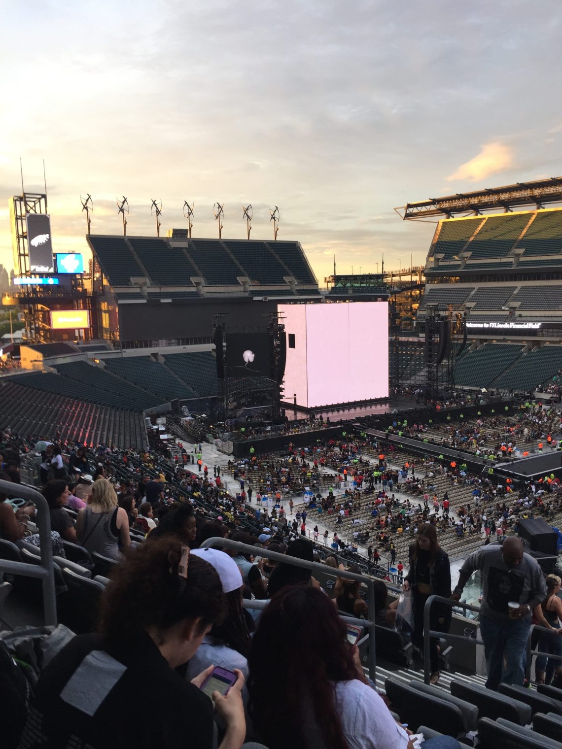 The Opening of a Concert with a large screen facing a filling stadium